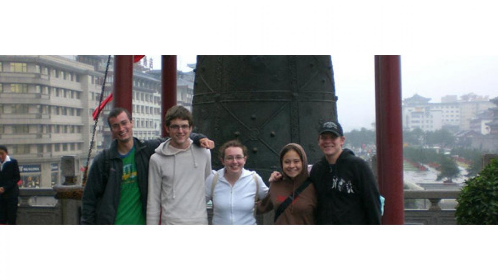 East Asian Studies students in front of a bell.