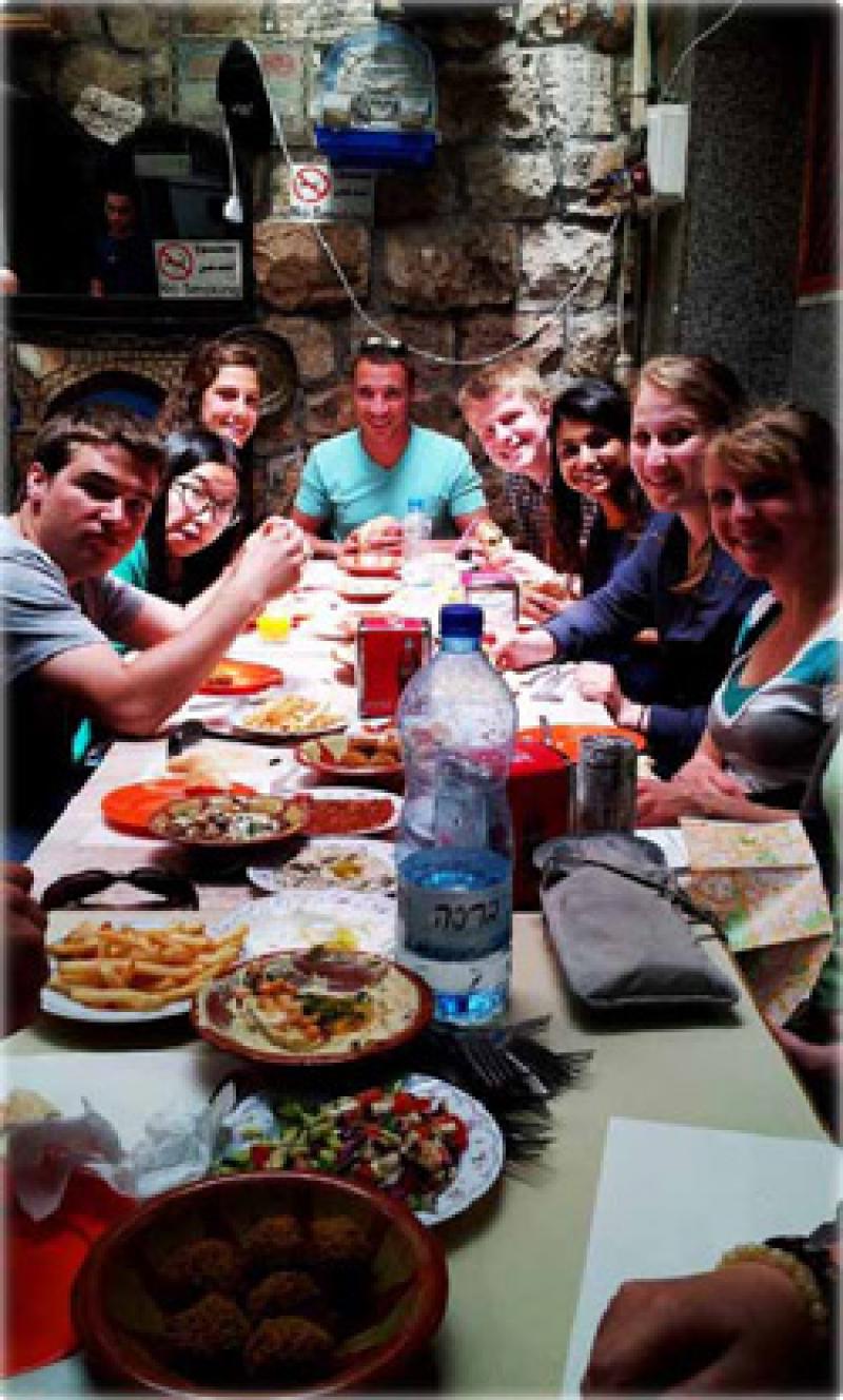 Group photo of Living Jerusalem students sharing a huge dinner.