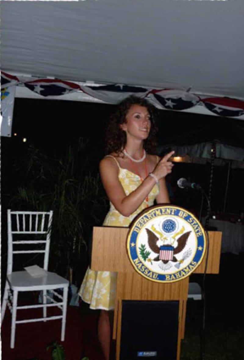 Erica Sayers at a U.S. State Department podium.