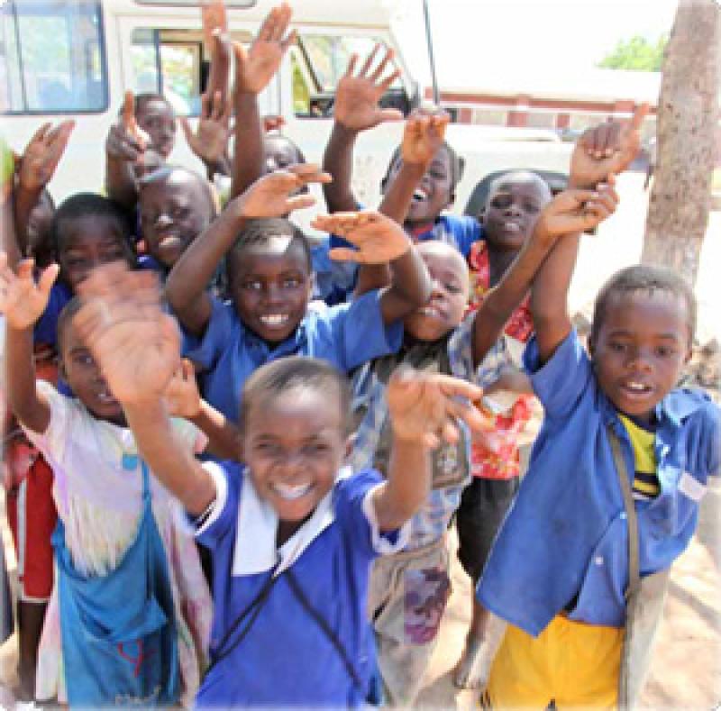 Children greeting the volunteers as they were getting out of the car.