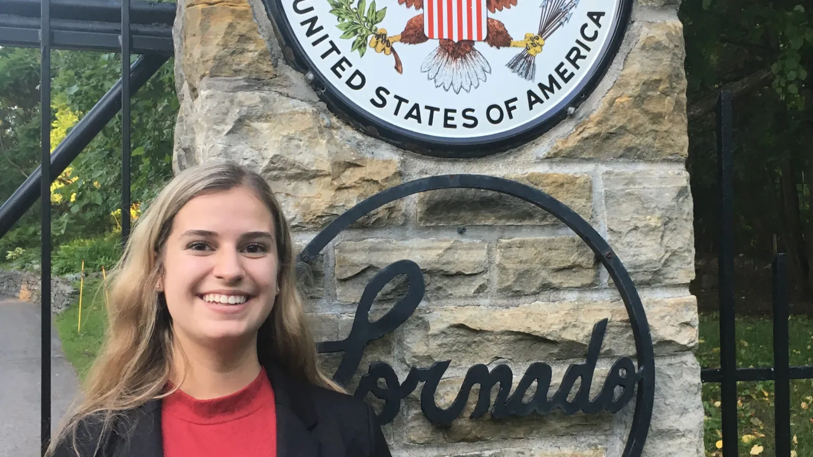 An image of Natalie Antonik in front of the US Embassy in Ottawa