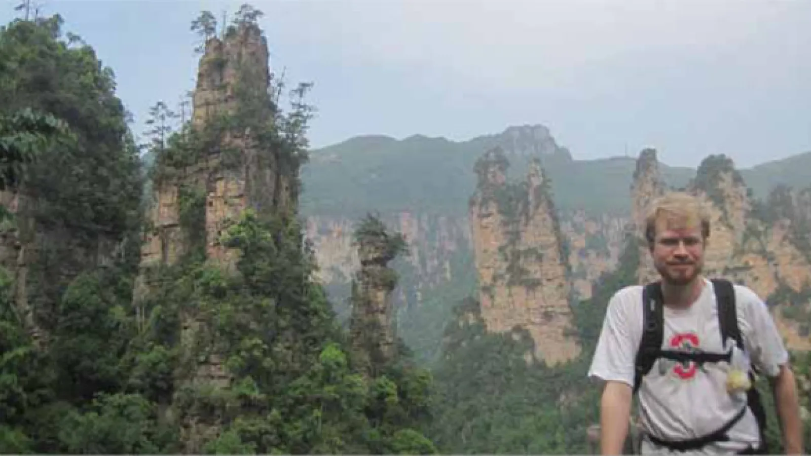 Alexander Long in front of the mountains in the Chinese wilderness.