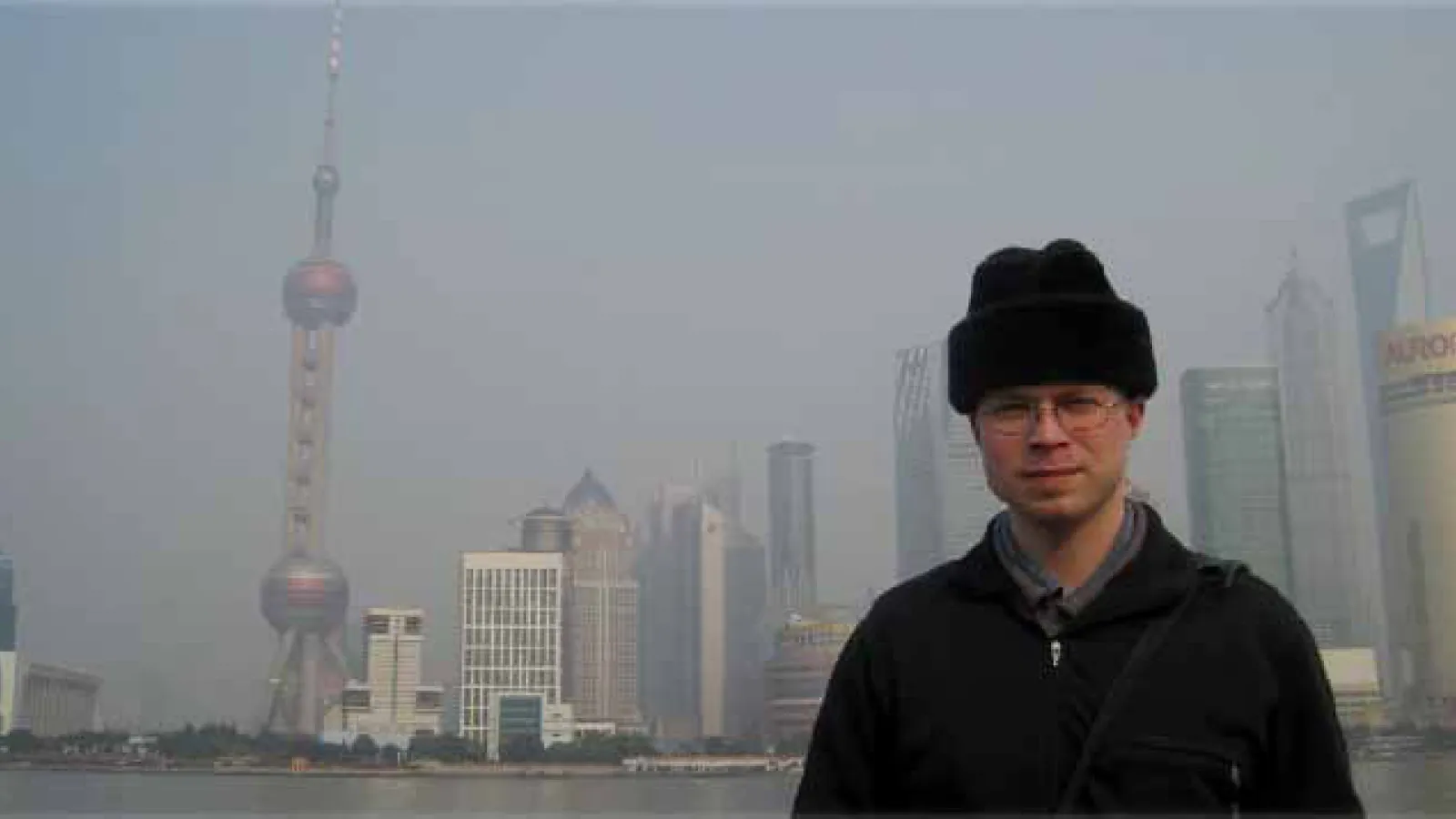 Alexander Long poses in front of the Shanghai bay.