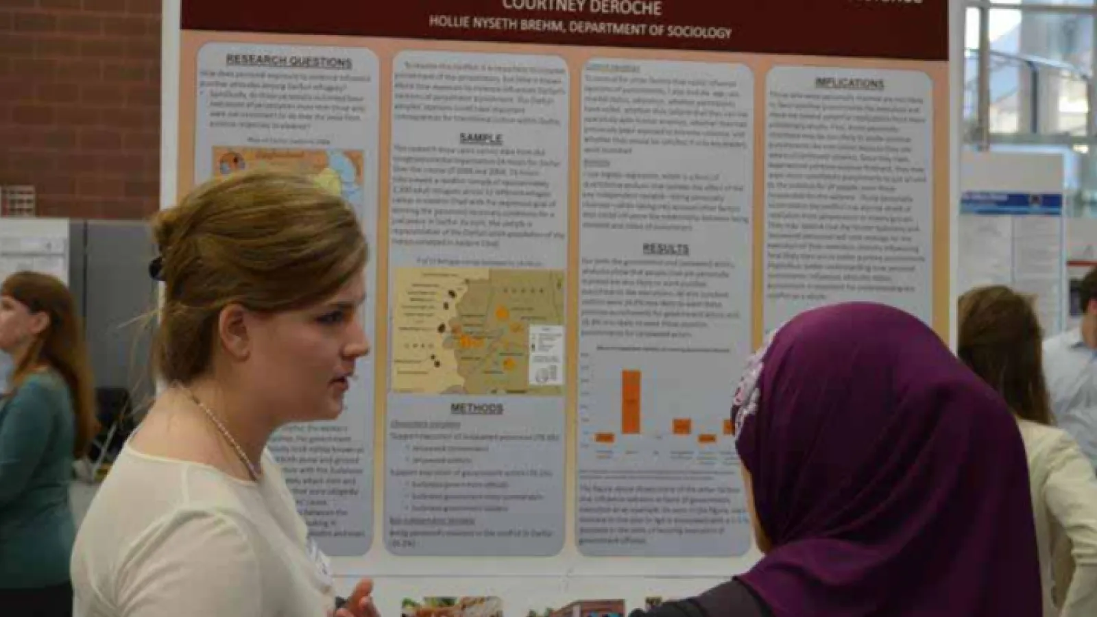 Courtney DeRoche presents her topic at the Denman Forum.