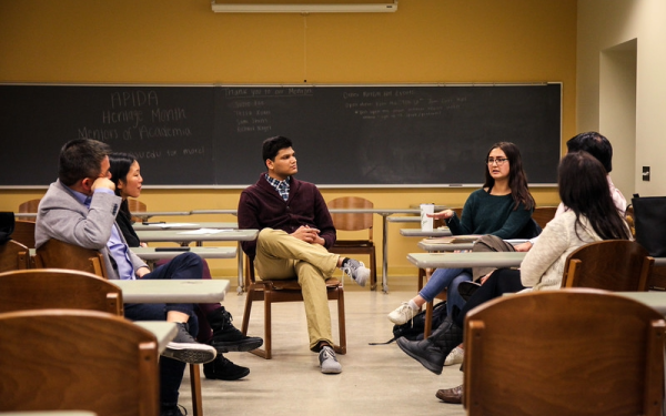 A group of students having a discussion in a classroom