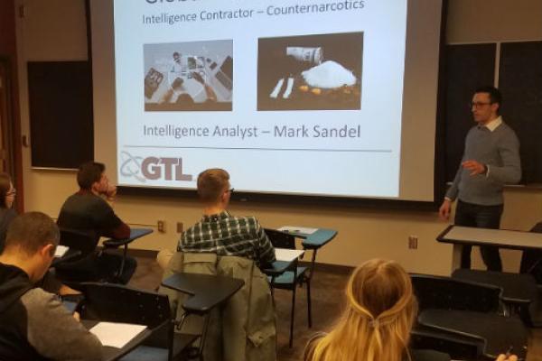 An image of Alum Mark Sandel delivering a presentation to the Security and Intelligence Club.