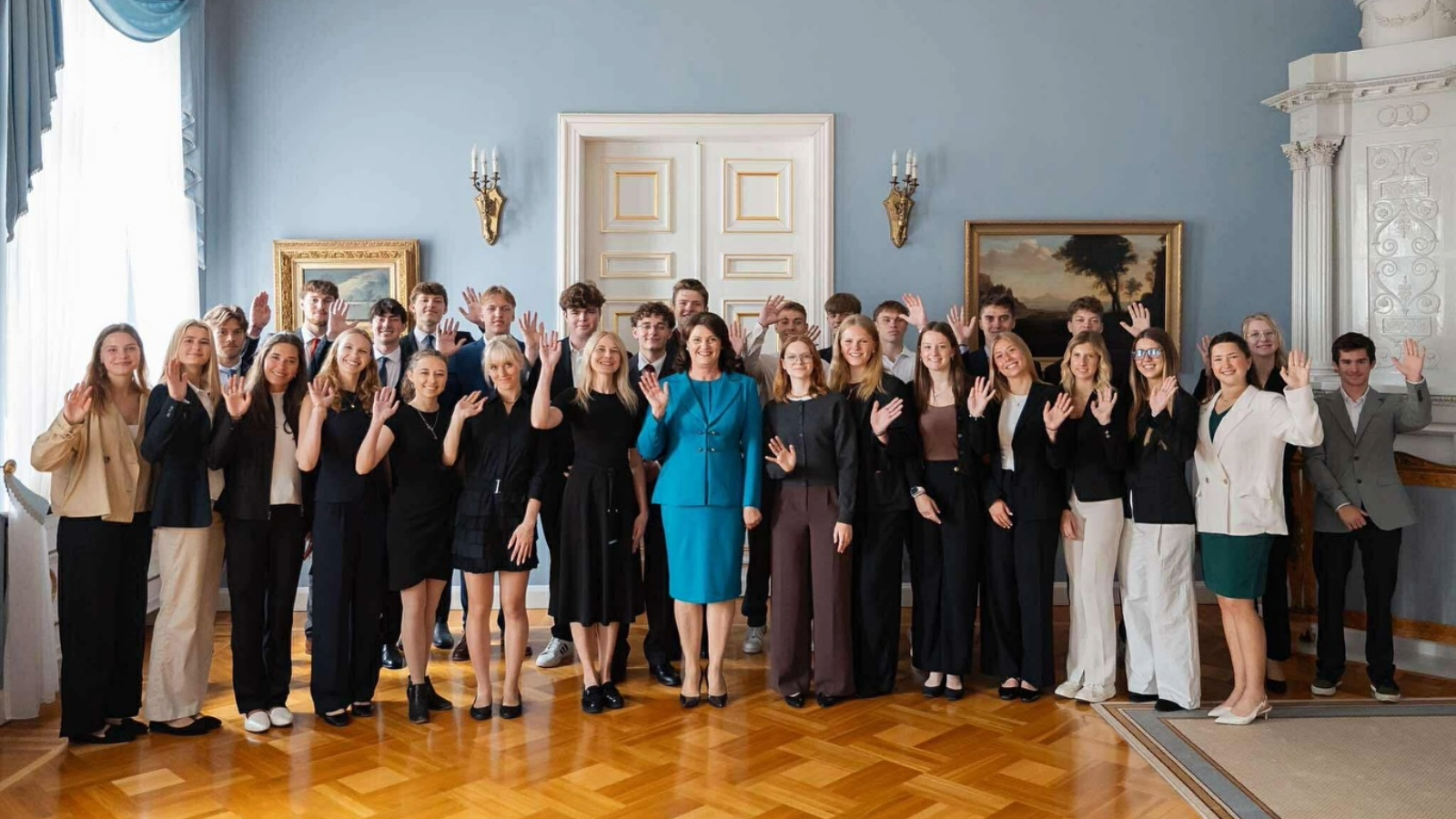 A large group of student interns inside of a government building in Vilnius, Lithuania
