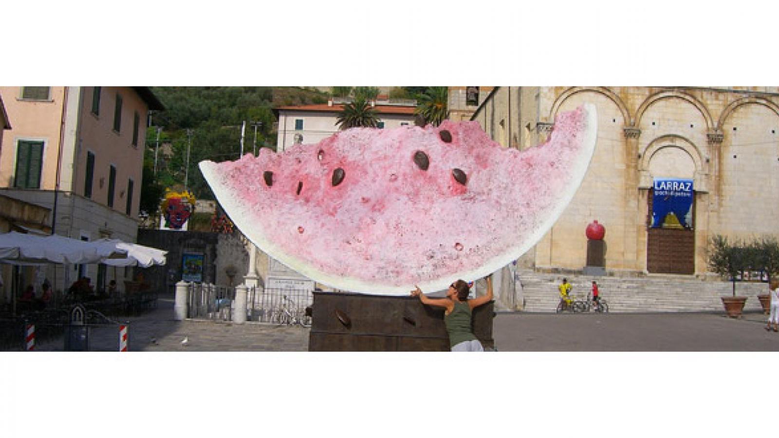 A statue of an enormous slice of watermelon.