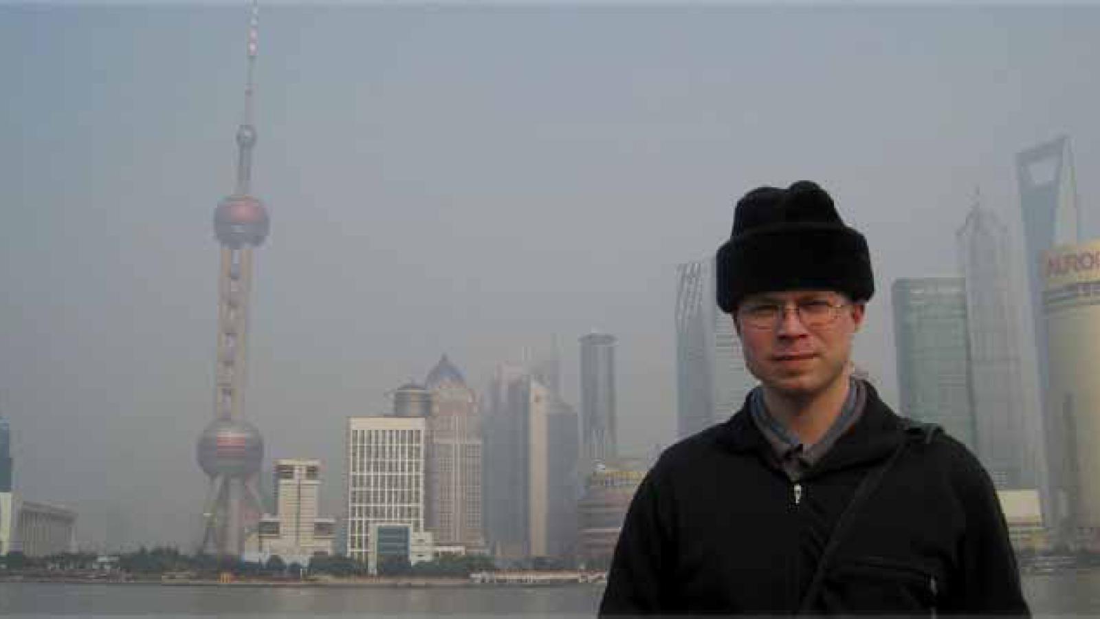 Alexander Long poses in front of the Shanghai bay.
