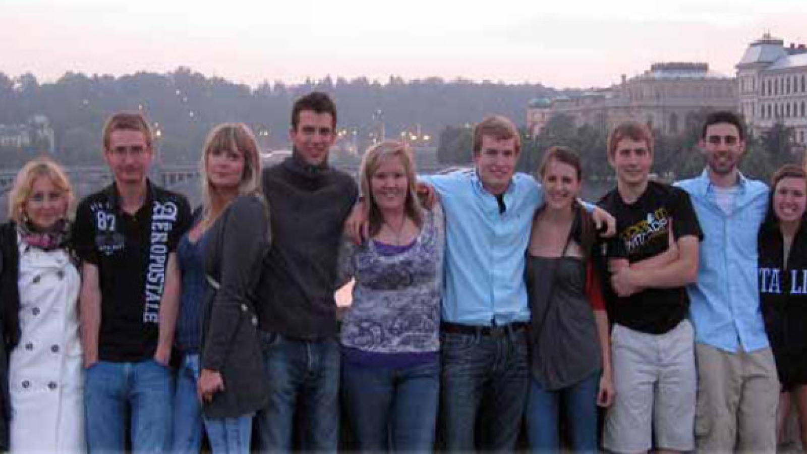 Students from a multitude of different countries pose for a picture with the Czech sunrise behind them.