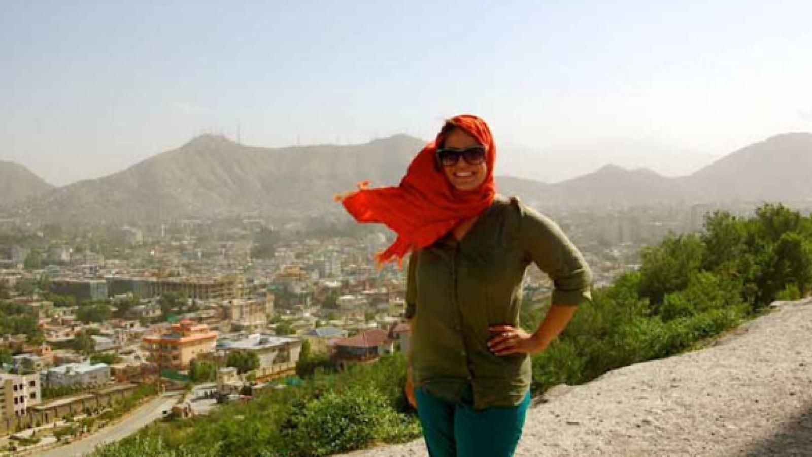 Meredith Leal on a cliff overlooking an Afghan town.