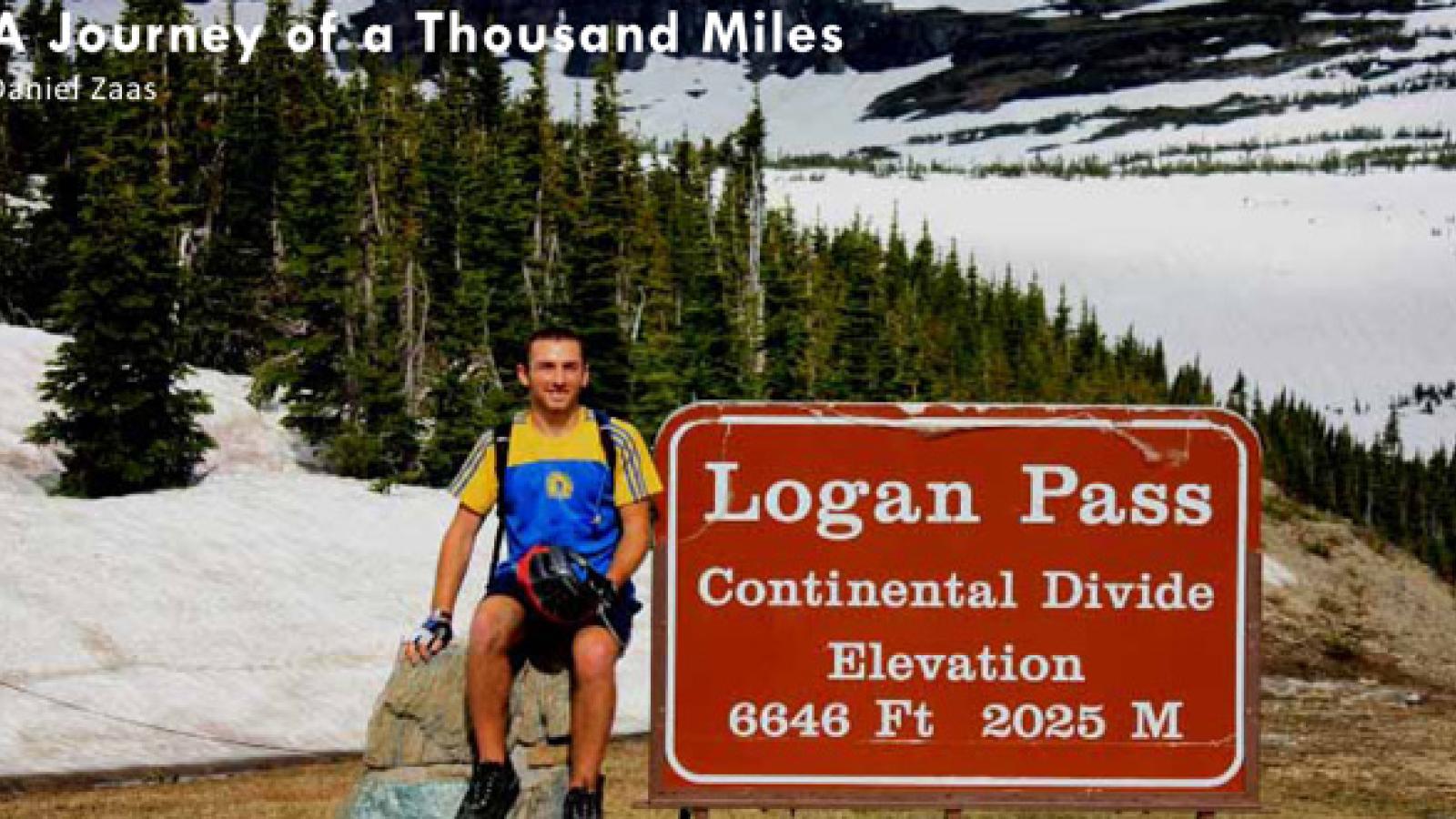 Daniel Zaas poses in front of snowy mountains.