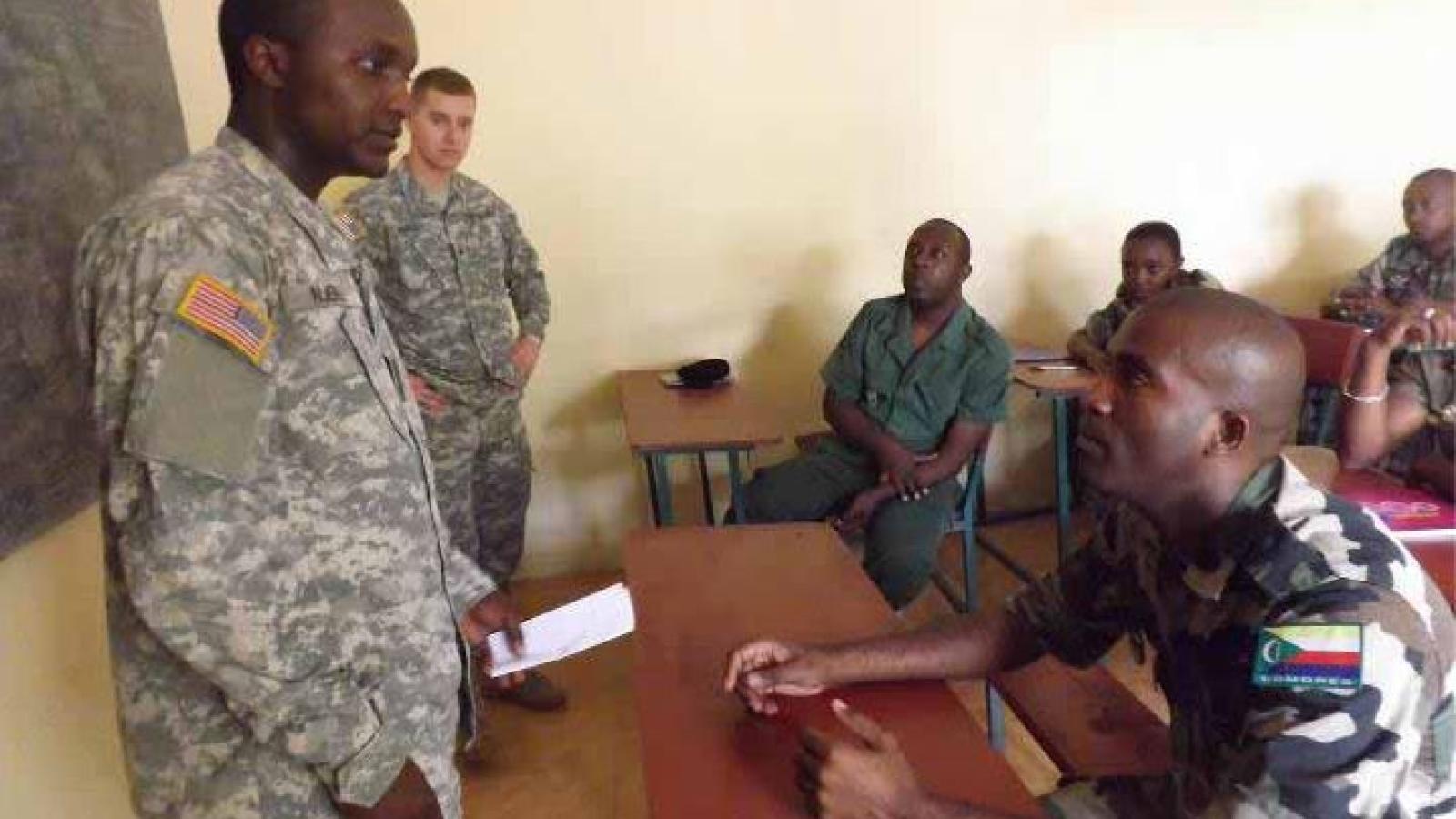 Patrick Njeru (left) addressing Comorian soldiers during his internship with AFRICOM in Vicenza, Italy.